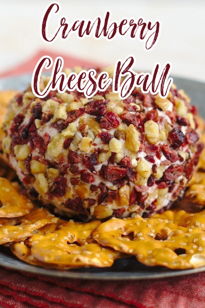 Cranberry Goat Cheese Ball - A quick and easy appetizer perfect for the holidays! Cranberry cinnamon goat cheese and cream cheese topped with dried cranberries and nuts! Cheese Ball Recipe | Cranberry Cheese Ball Recipe | Holiday Cheese Ball